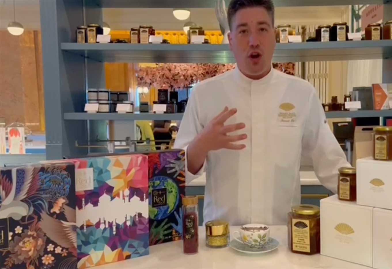 Photo of the famous Chef Francois Leo, standing next to a table showcasing Red24 Saffron and boxes of honey at the Emirates Palace.